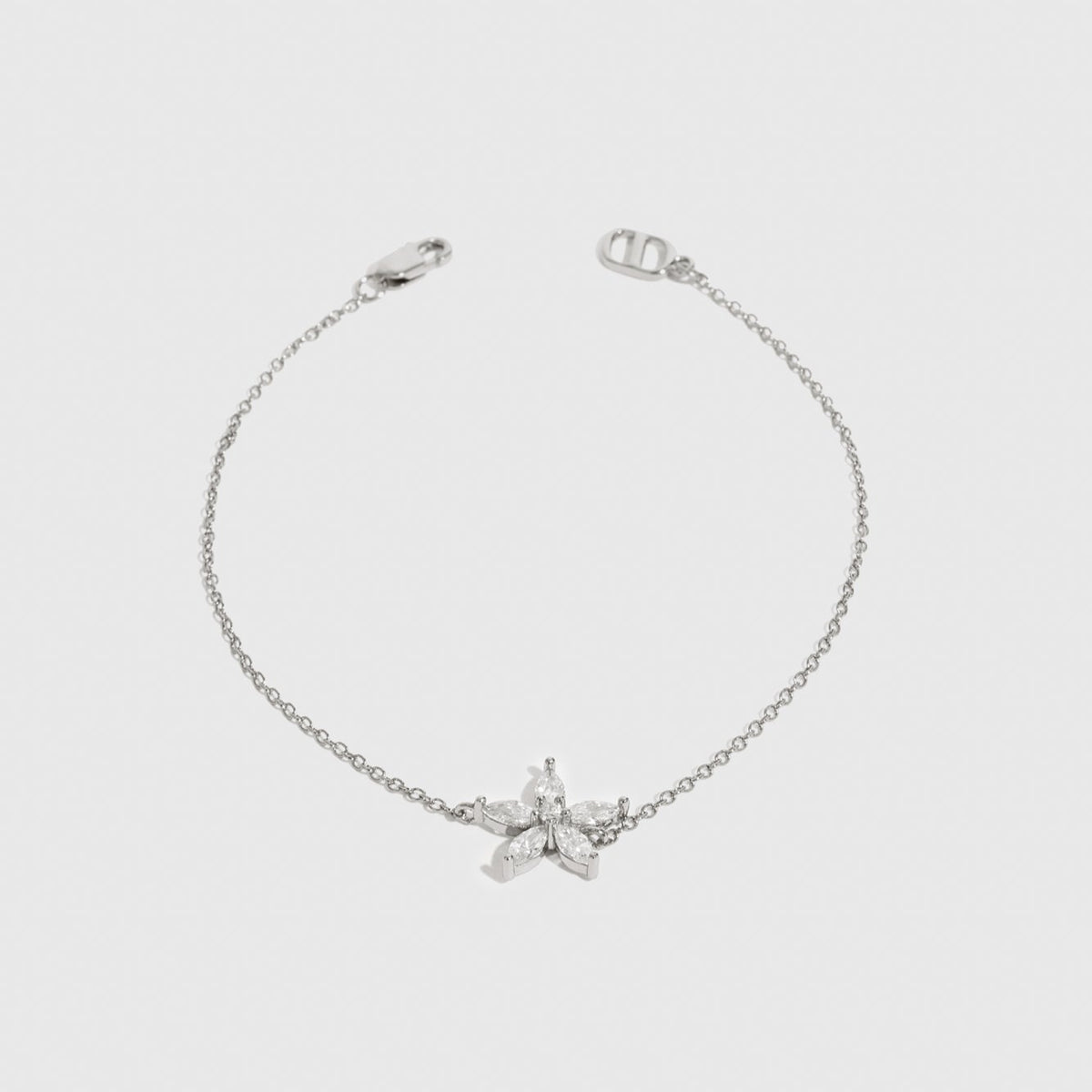 Sterling silver 925 flower solitaire bracelet with a pure white cubic zirconia, shown on a plain background.